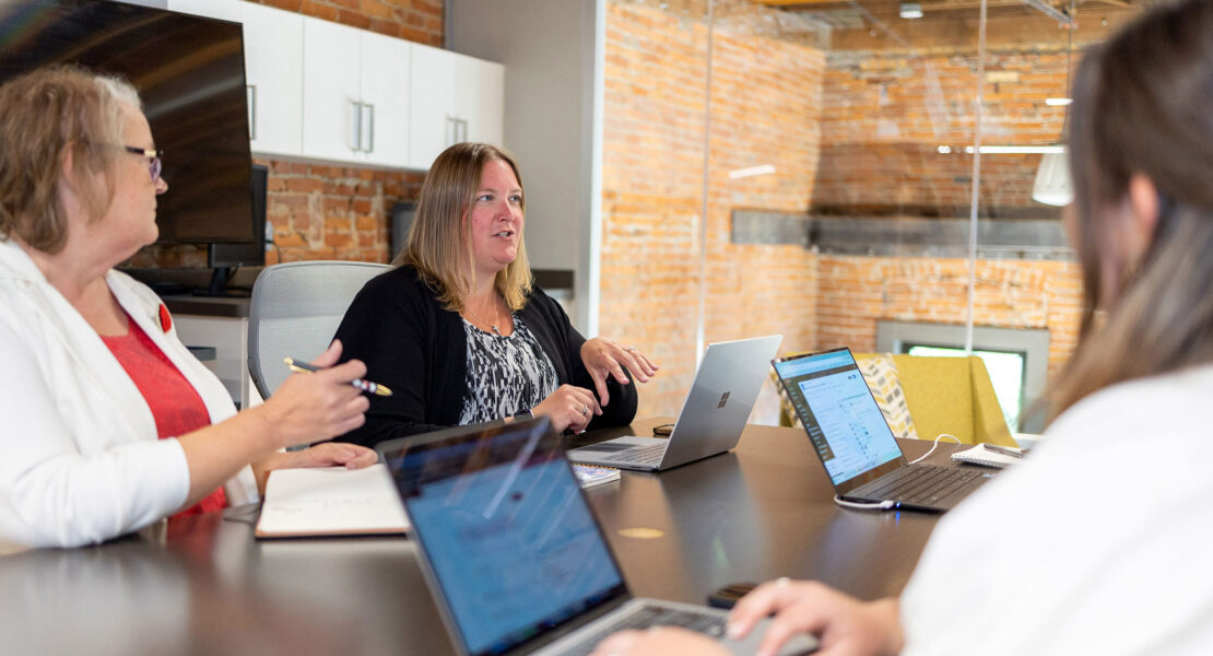 A team brainstorming franchise operations ideas using whiteboards and notes in a collaborative space.